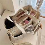 Beige canvas tote met stevige riemen en ruim hoofdvak.