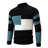 Zwarte trui met wit en turquoise kleurvlak
